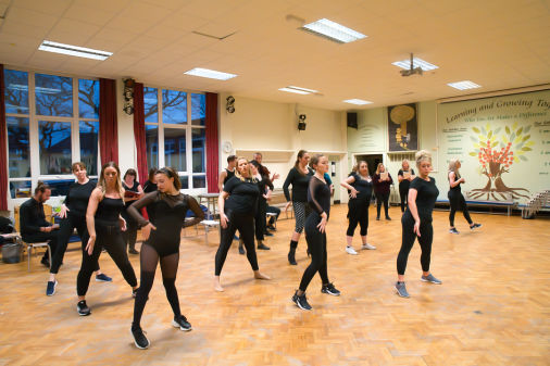 female and male dancers and actors at a rehearsal for Chicago 