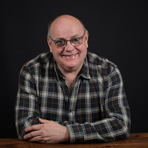 Male corporate headshot shot on a black background