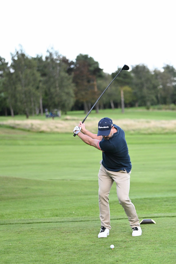 A man playing golf on a Corporate Golf day in stockport.